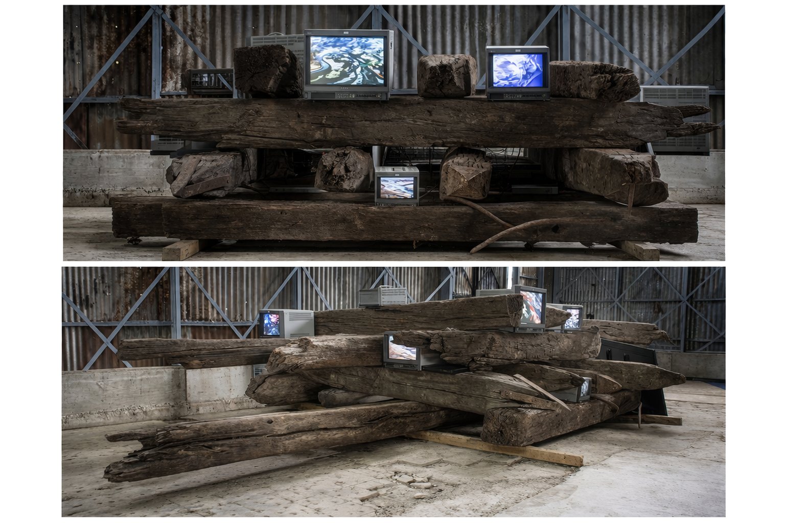 Installation with screens placed among wooden earthquake residues.